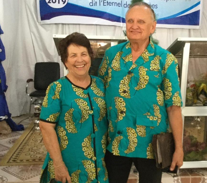 Les fondateurs de l'établissement, souriants, dans des tenues assorties en pagne turquoise.